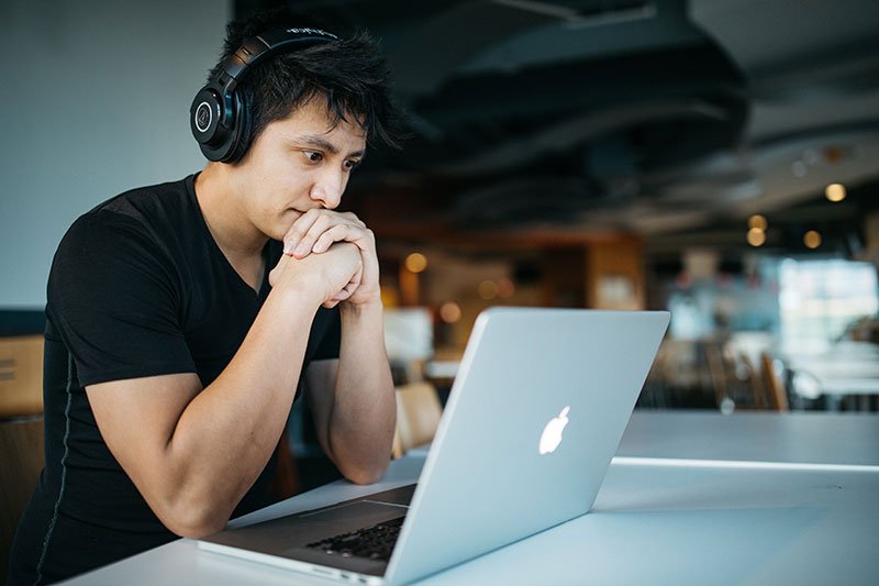 Become a teacher man at a laptop.